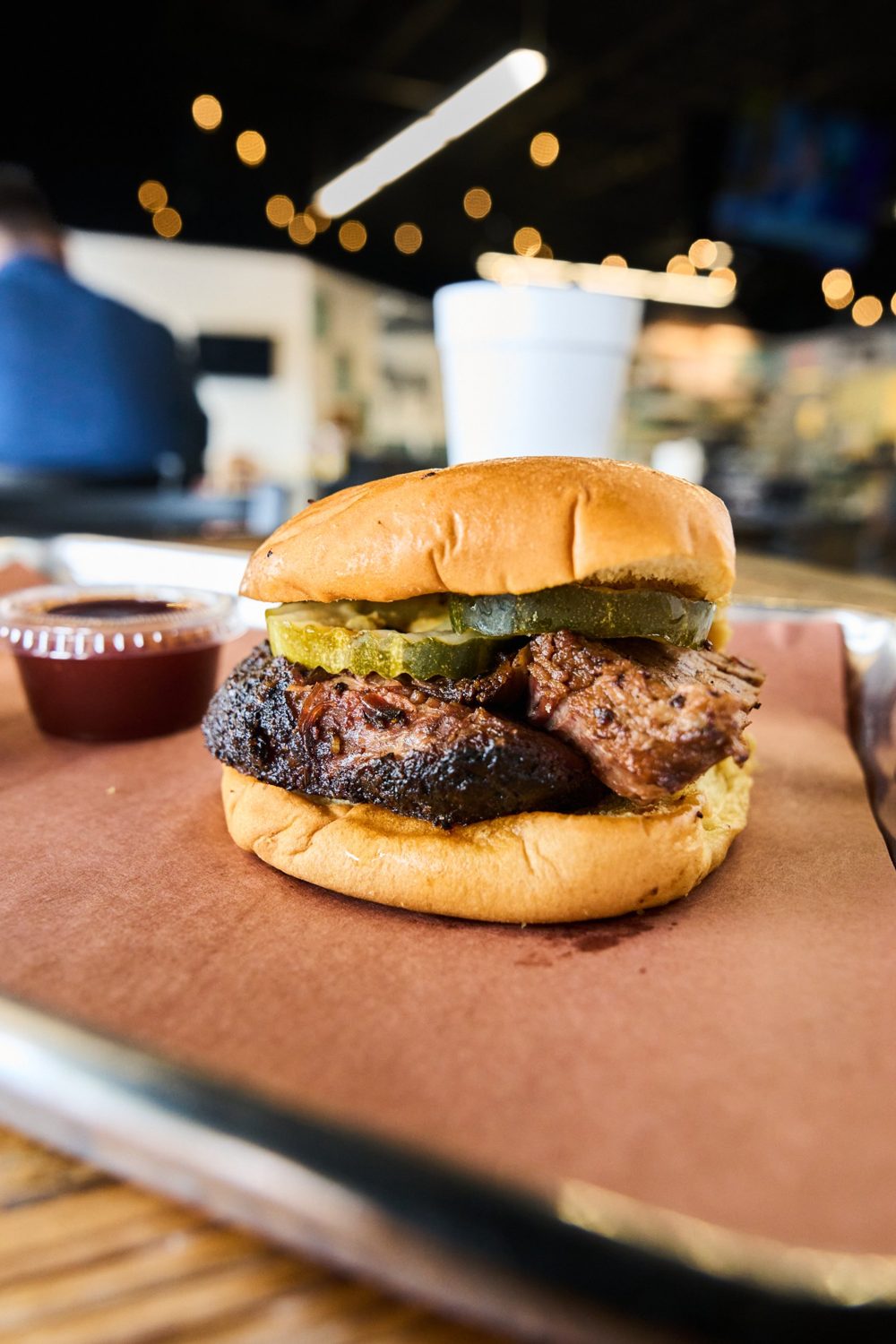 Brisket sandwich with pickles on a potato roll