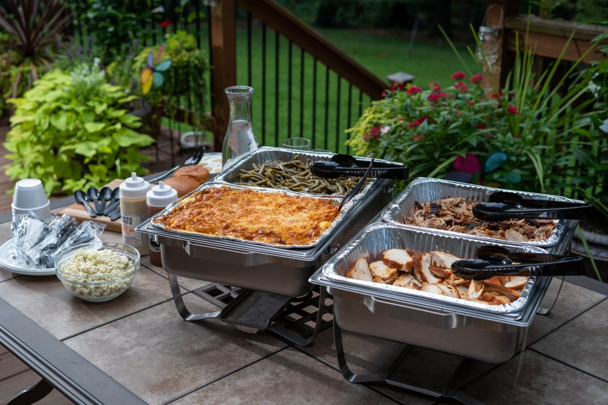 Chafing dishes set up on an outdoor table