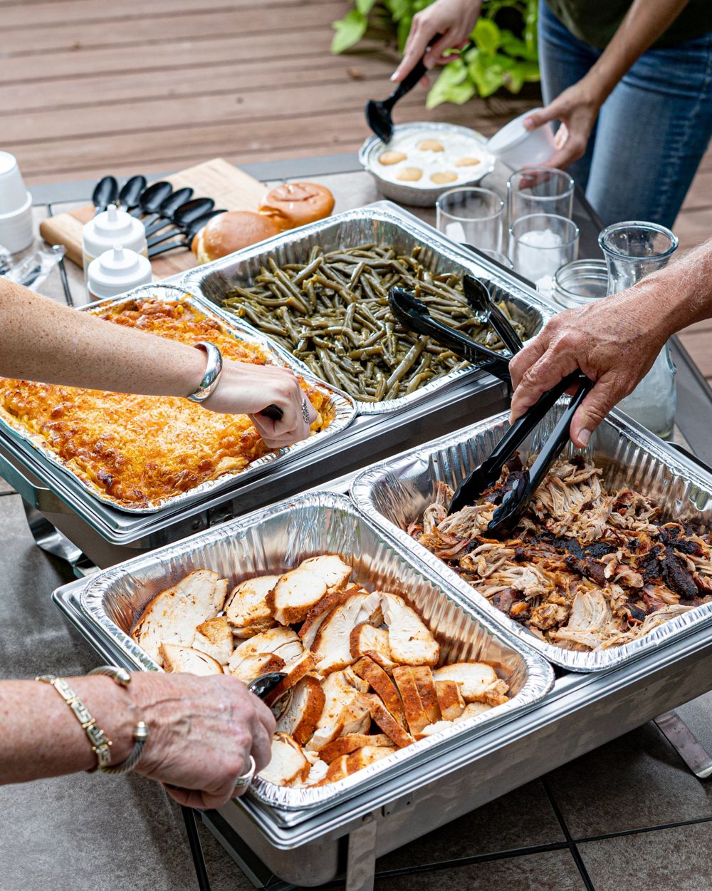 Guests serving themselves from catering trays