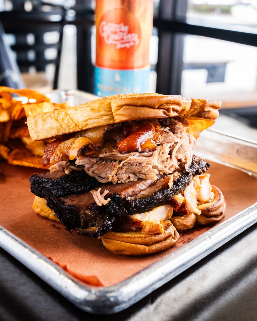 The Soul Saver sandwich stacked with brisket, pulled pork, chicken and bacon